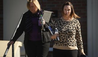 Shannon Allen, right, wife of Sgt. First Class Mark Allen, leaves the Fort Bragg Courtroom Facility after testifying at the Sgt. Bowe Bergdahl sentencing hearing on Monday, Oct. 30, 2017, on Fort Bragg, N.C. Sgt. First Class Mark Allen was critically injured during the search mission for Bergdahl. Bergdahl, who walked off his base in Afghanistan in 2009 and was held by the Taliban for five years, is charged with desertion and misbehavior before the enemy. (AP Photo/The Fayetteville Observer, Andrew Craft) ** FILE **