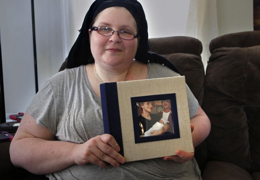 In this Friday, Oct. 20, 2017, photo, Bethany Miller poses for a photo as she holds a photo album with her late son Kyle Wilson and his daughter on the cover in Jay, Maine. Miller said her son, who died from a diabetic coma, would've been among those in Maine who could benefit if voters on Nov. 7 demand a Medicaid expansion. "He had a job, but he didn’t make enough money to pay for his basic needs and his insulin, and he couldn't live without his insulin," said Miller. (AP Photo/Robert F. Bukaty)