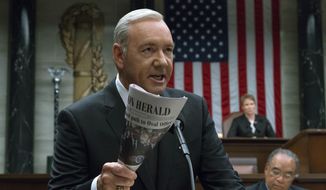 This image released by Netflix shows Kevin Spacey in a scene from &amp;quot;House Of Cards.&amp;quot; Netflix says it&#39;s suspending production on &amp;quot;House of Cards&amp;quot; following harassment allegations against Spacey.  (David Giesbrecht/Netflix via AP)