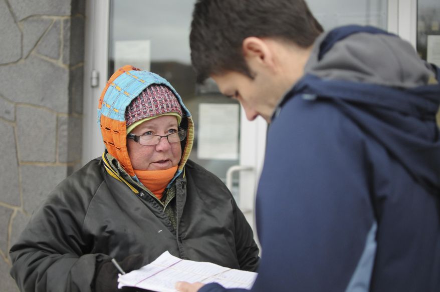 Petition circulator Sam Lopez, left, gathers signatures in Sioux Falls, S.D., Monday, Oct. 30, 2017. Initiative campaigns hoping to go before voters in 2018 face a crucial deadline next week to turn in thousands of names each to the Secretary of State's office. (AP Photo/James Nord)