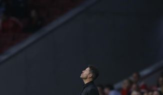 Atletico coach Diego Simeone looks up to the sky during a Group C Champions League soccer match between Atletico Madrid and Qarabag at the Metropolitano stadium in Madrid, Spain, Tuesday, Oct. 31, 2017. (AP Photo/Paul White)