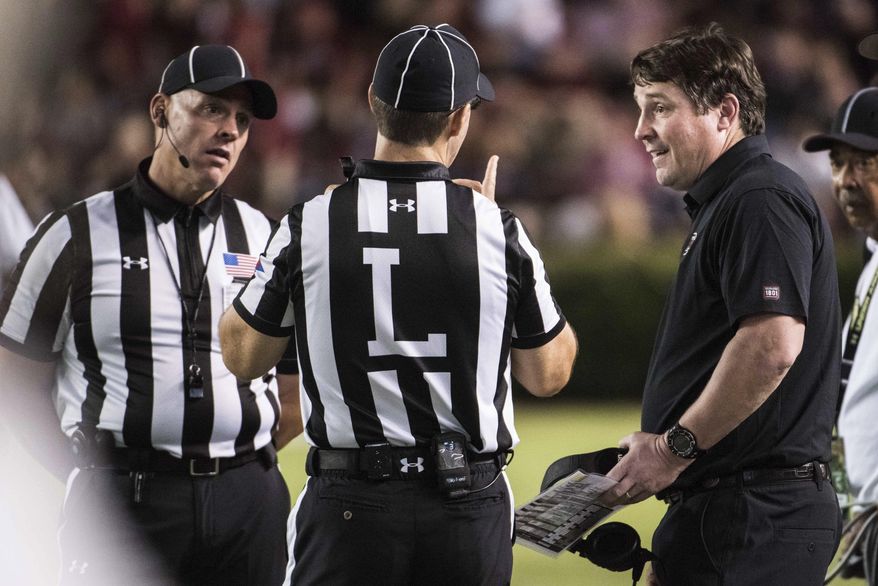 South Carolina head coach Will Muschamp, right, talks with officials during the second half of an NCAA college football game against Vanderbilt, Saturday, Oct. 28, 2017, in Columbia, S.C. (AP Photo/Sean Rayford)