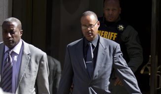 In this June 10, 2016, file photo, Officer Caesar Goodson, center, leaves the courthouse after his trial in the death of Freddie Gray in Baltimore. (AP Photo/Jose Luis Magana, File)