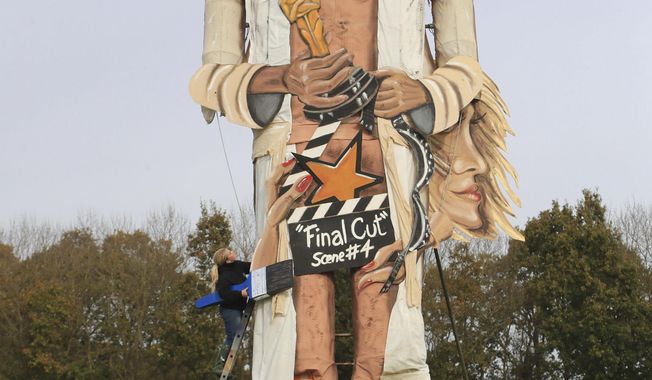 Artists Frank Shepherd and Andrea Deans put the finishing touches to the Edenbridge Bonfire Society effigy, which has been unveiled as Harvey Weinstein, for Bonfire Night in Edenbridge, England, Wednesday, Nov. 1, 2017. (Gareth/PA via AP)