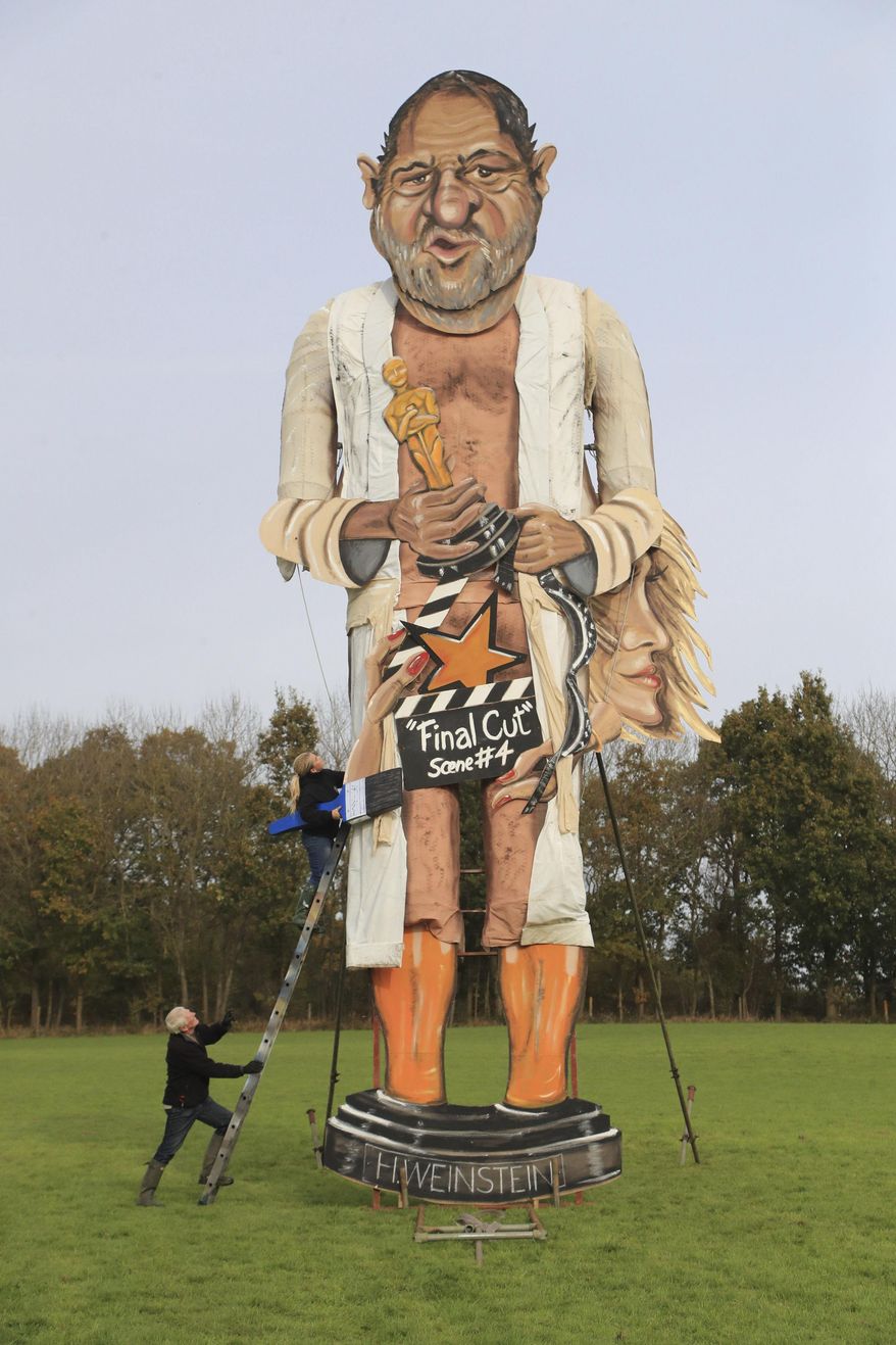 Artists Frank Shepherd and Andrea Deans put the finishing touches to the Edenbridge Bonfire Society effigy, which has been unveiled as Harvey Weinstein, for Bonfire Night in Edenbridge, England, Wednesday, Nov. 1, 2017. (Gareth/PA via AP)