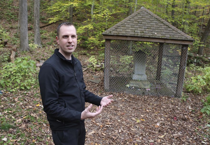 Former ghost hunter Walter Hutsky Jr. recalls legends at the Lost Children of the Alleghenies Monument, also known as the Cox Monument, in Blue Knob State Park near Pavia, Pa., Thursday, Oct.26, 2017. The bodies of two lost boys, ages seven and five, were found here in May, 1856, after they went missing ten days prior. A man unfamiliar to the area who dreamed twice of the location, led a search party straight to them. Some think the area in haunted.(Randy Griffith/Tribune-Democrat via AP)