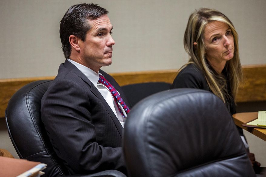 Michigan Department of Health and Human Services Director Nick Lyon, left, appears in court with Britt Cobb, one of his attorneys, for his ongoing preliminary examination on Wednesday, Nov. 1, 2017, in Genesee County District Court in downtown Flint, Mich. Lyon faces charges of involuntary manslaughter and misconduct in office for his response to the Flint water crisis. (Terray Sylvester/The Flint Journal-MLive.com via AP)