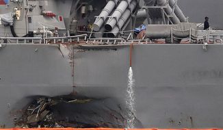 FILE - In this Aug. 22, 2017, file photo, the damaged port aft hull of the USS John S. McCain, is visible while docked at Singapore&#39;s Changi naval base in Singapore. U.S. Navy leaders are recommending a sweeping list of changes in sailor training, crew requirements and safety procedures to address systemic problems across the Pacific fleet that led to two deadly ship collisions earlier this year, killing 17 sailors. A report scheduled to be released Nov. 2, calls for about 60 recommended improvements that range from improved training on seamanship, navigation and the use of ship equipment to more basic changes to increase sleep and stress management for sailors.  (AP Photo/Wong Maye-E, File)