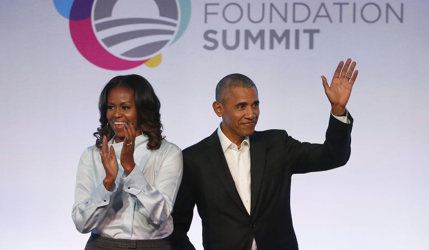 Former President Barack Obama, right, and former first lady Michelle Obama arrive for the first session of the Obama Foundation Summit Tuesday, Oct. 31, 2017, in Chicago. (AP Photo/Charles Rex Arbogast)