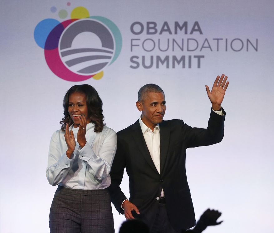 Former President Barack Obama, right, and former first lady Michelle Obama arrive for the first session of the Obama Foundation Summit Tuesday, Oct. 31, 2017, in Chicago. (AP Photo/Charles Rex Arbogast)