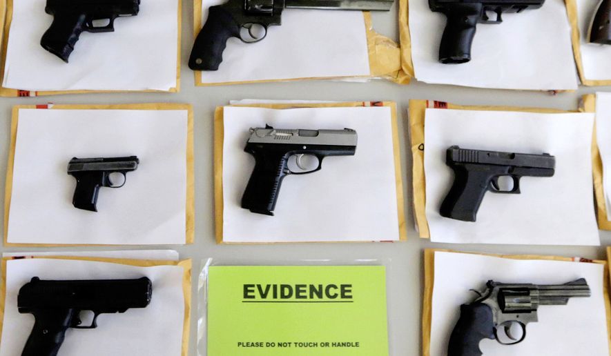In this July 7, 2014, file photo, Chicago police display some of the thousands of illegal firearms confiscated during the year. In a government report released on Friday, Nov. 3, 2017, the U.S. rate for gun deaths has increased for the second straight year, following 15 years of no real change. (AP Photo/M. Spencer Green, File)