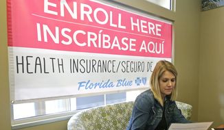 Catherine Reviati reviews the different Affordable Care Act enrollment options, Thursday, Nov. 2, 2017, in Hialeah, Fla. (AP Photo/Alan Diaz) ** FILE **
