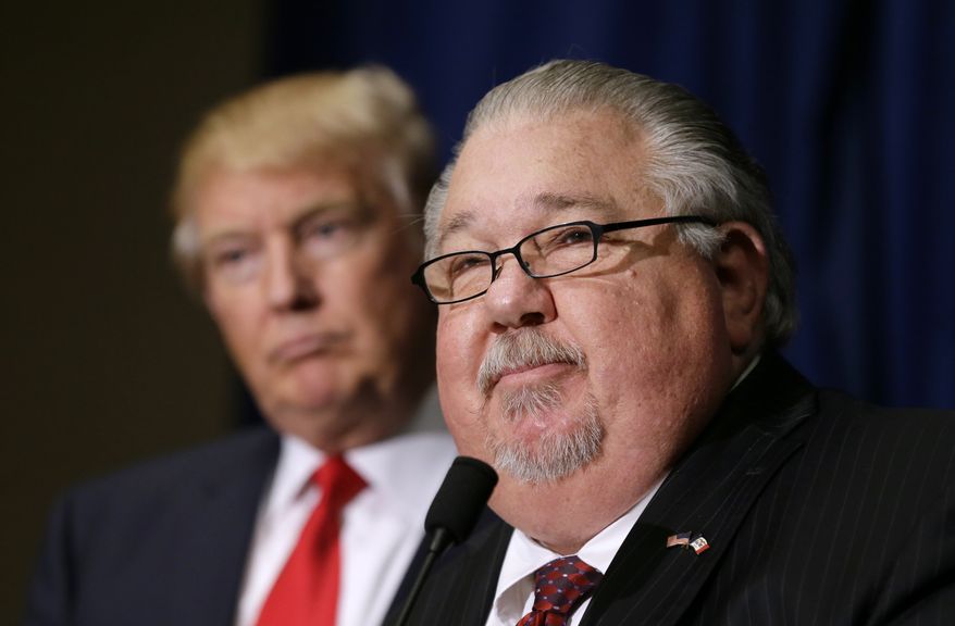 FILE - In this Aug. 25, 2016, file photo, Sam Clovis speaks during a news conference as then-Republican presidential candidate Donald Trump, left, watches before a campaign rally in Dubuque, Iowa. Clovis, a former Trump campaign official who has been linked to the investigation by special counsel Robert Mueller, has withdrawn his nomination for an Agriculture post. (AP Photo/Charlie Neibergall)