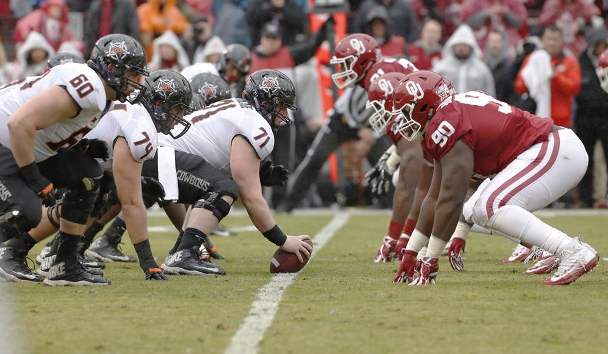 FILE - In this Dec. 3, 2016, file photo, Oklahoma State, right, gets ready for a play against Oklahoma during the first half of an NCAA college football game, in Norman, Okla. For only the second time in 13 years, No. 8 Oklahoma (7-1, 4-1 Big 12) and No. 11 Oklahoma State (7-1, 4-1) are meeting before the final game of the regular season. The Sooners and the Cowboys are part of a four-way tie atop the conference standings with four games left before the league’s championship game. There is the possibility they could meet again Dec. 2, no matter who wins Saturday in Stillwater. (AP Photo/Alonzo Adams, File)