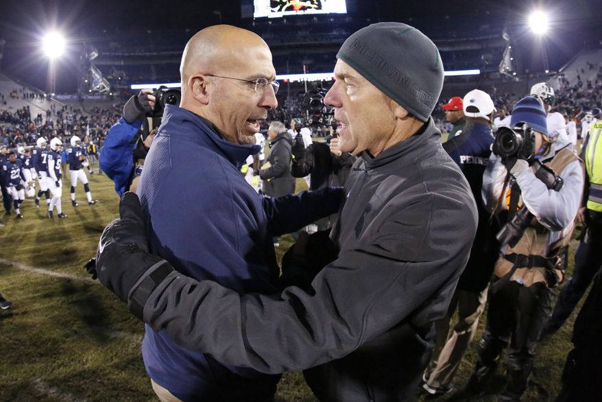 FILE - In this Nov. 29, 2014, file photo, Penn State head coach James Franklin, left, and Michigan State head coach Mark Dantonio meet on the field after a 34-10 Michigan State win in an NCAA college football game in State College, Pa. No. 7 Penn State visits No. 24 Michigan State in a game in which both teams are looking to bounce back from losses while playing for the Land Grant Trophy. (AP Photo/Gene J. Puskar, File)
