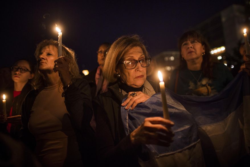 People gather to remember the victims of the recent truck attack during a candle light walk along Hudson River coast near the crime scene on Thursday, Nov. 2, 2017, in New York. A man in a rented pickup truck mowed down pedestrians and cyclists along the busy bike path near the World Trade Center memorial on Tuesday, killing at least eight and seriously injuring others in what the mayor called "a particularly cowardly act of terror." (AP Photo/Andres Kudacki)