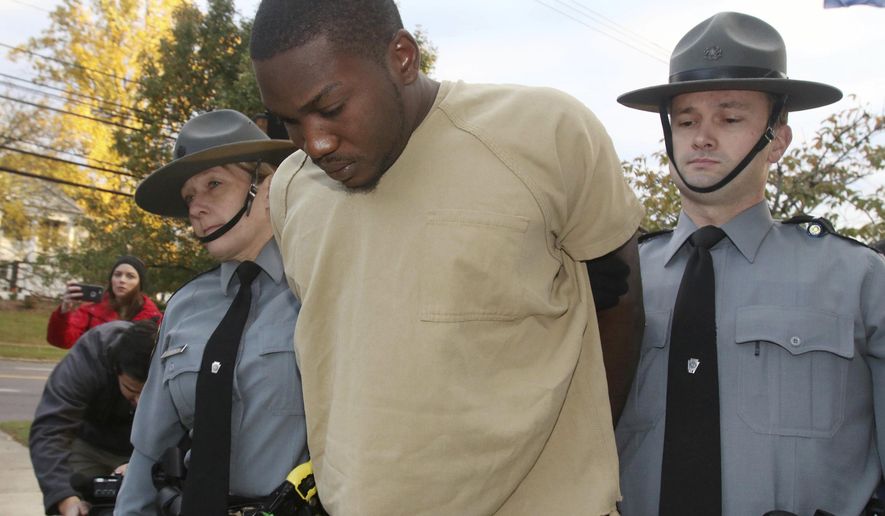 Flanked by Pennsylvania State police, Preston Bonnett is lead into Wyoming Pa. State Police Barracks Monday, Oct. 30th 2017. Bonnett 26 of Wilkes -Barre Pa was charged with two counts of criminal homicide and three counts of arson in a blaze that took the lives of Erik Dupree 16, Devon Major 12, and Ezekiel Major 7 in Laflin Pa. on Oct. 25. 2017. (Dave Scherbenco/The Citizens' Voice via AP)