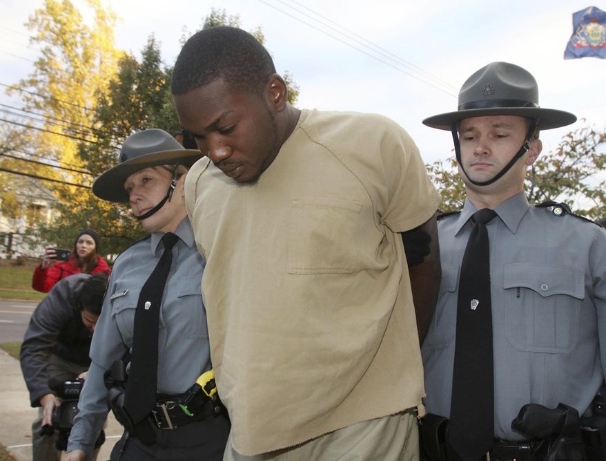 Flanked by Pennsylvania State police, Preston Bonnett is lead into Wyoming Pa. State Police Barracks Monday, Oct. 30th 2017. Bonnett 26 of Wilkes -Barre Pa was charged with two counts of criminal homicide and three counts of arson in a blaze that took the lives of Erik Dupree 16, Devon Major 12, and Ezekiel Major 7 in Laflin Pa. on Oct. 25. 2017. (Dave Scherbenco/The Citizens' Voice via AP)