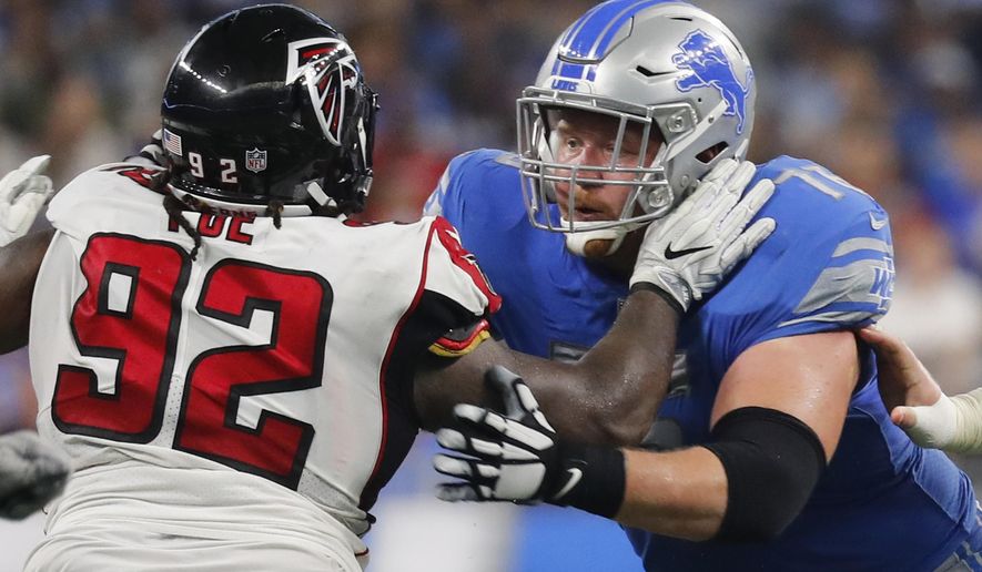 FILE - In this Sept. 24, 2017, file photo, Detroit Lions offensive guard T.J. Lang, right, blocks Atlanta Falcons defensive tackle Dontari Poe (92) during an NFL football game in Detroit. Lang, who played for the Green Bay Packers from 2009-2016, will play against his former team on Monday, Nov. 6. (AP Photo/Paul Sancya, File)