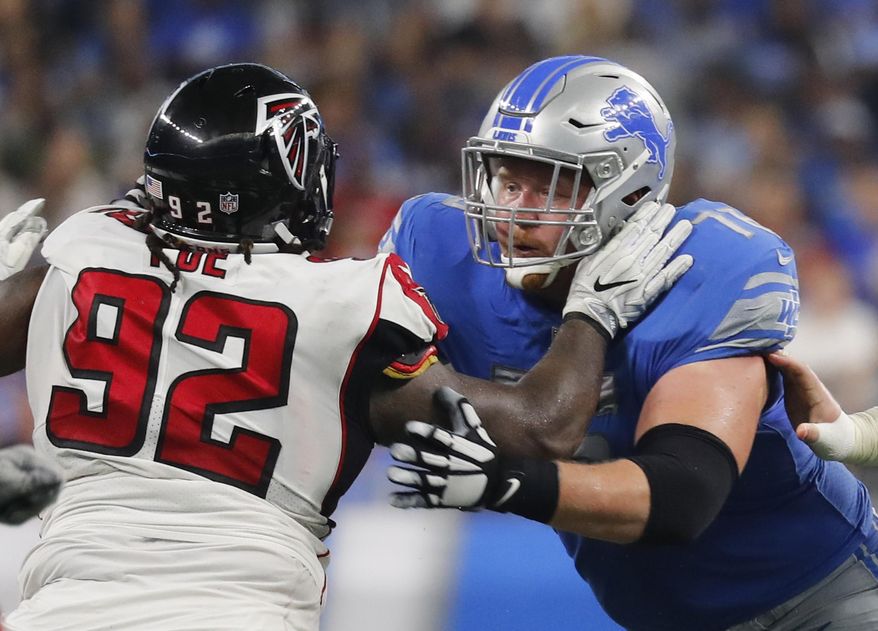 FILE - In this Sept. 24, 2017, file photo, Detroit Lions offensive guard T.J. Lang, right, blocks Atlanta Falcons defensive tackle Dontari Poe (92) during an NFL football game in Detroit. Lang, who played for the Green Bay Packers from 2009-2016, will play against his former team on Monday, Nov. 6. (AP Photo/Paul Sancya, File)