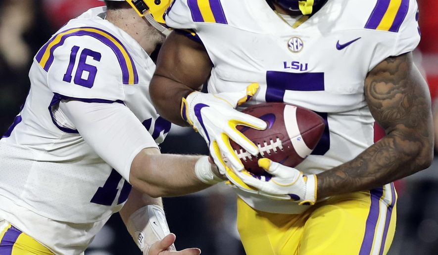 LSU quarterback Danny Etling (16) hands the ball off to running back Derrius Guice (5) during the first half of an NCAA college football game against Mississippi in Oxford, Miss., Saturday, Oct. 21, 2017. No. 24 LSU won 40-24. (AP Photo/Rogelio V. Solis)