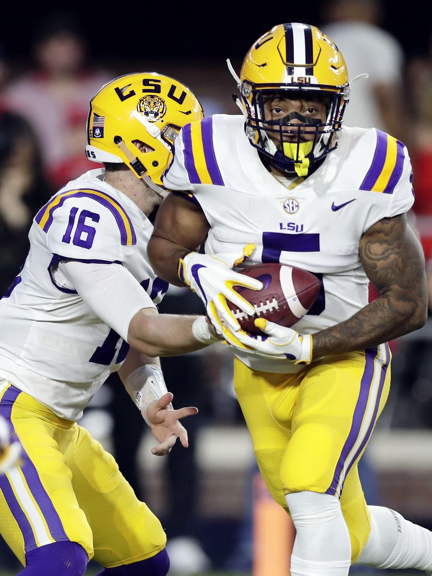 LSU quarterback Danny Etling (16) hands the ball off to running back Derrius Guice (5) during the first half of an NCAA college football game against Mississippi in Oxford, Miss., Saturday, Oct. 21, 2017. No. 24 LSU won 40-24. (AP Photo/Rogelio V. Solis)