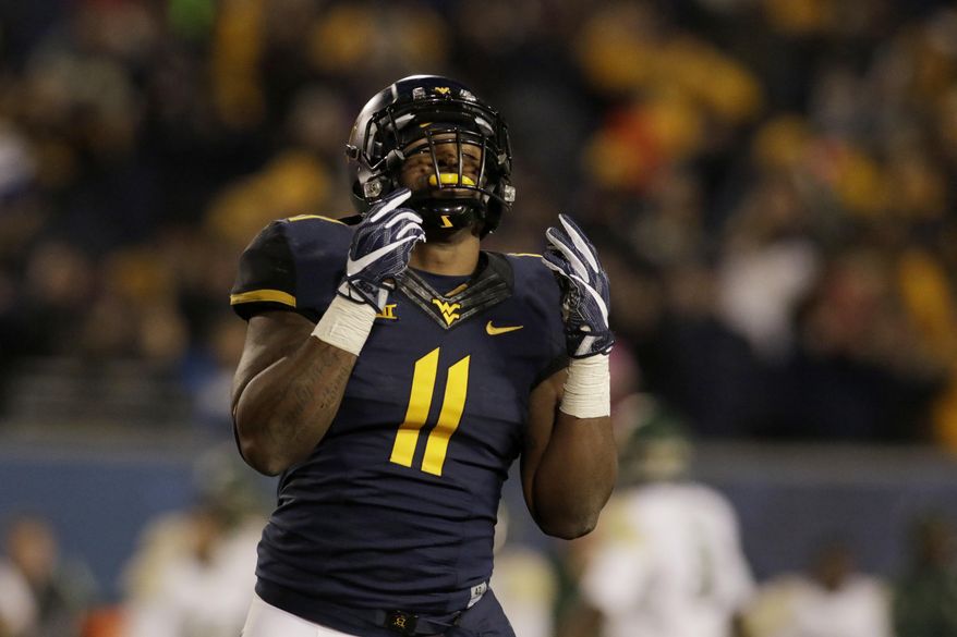 FILE - In this Dec. 3, 2016, file photo, West Virginia linebacker David Long (11) celebrates a defensive play during the second half of an NCAA college football game against Baylor, in Morgantown, W.Va. On a defense that has been consistently porous this season, West Virginia's David Long Jr. has become one of the unit's bright spots at outside linebacker. (AP Photo/Raymond Thompson, File)