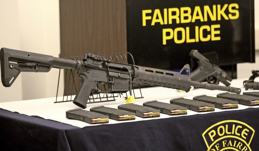 This photo shows a display of the actual weapons and ammunition Matthew Stover was armed with during a Fairbanks Police Department press briefing Thursday afternoon, Nov. 2, 2017 in Fairbanks, Alaska. The man who was killed in June after firing at officers came prepared to kill, not die, wearing a bullet-proof mask and dressed head to toe in modified body armor, Fairbanks Police Chief Eric Jewkes said. (Eric Engman/Fairbanks Daily News-Miner via AP)