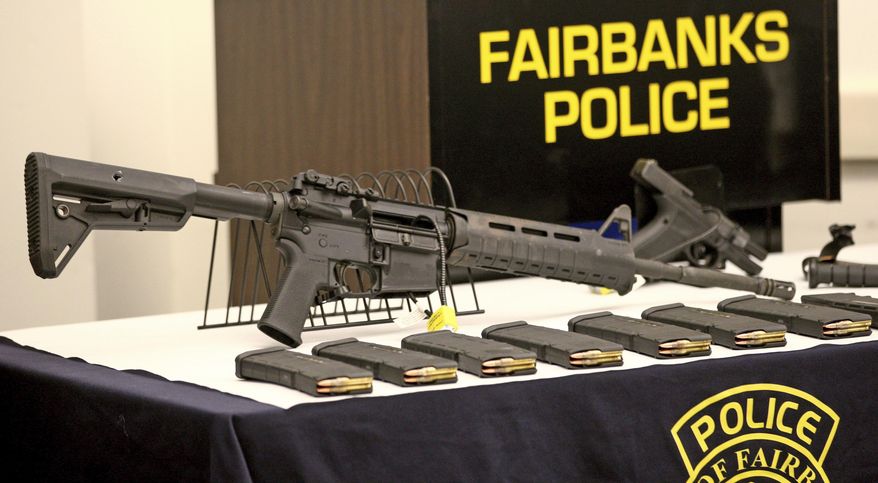 This photo shows a display of the actual weapons and ammunition Matthew Stover was armed with during a Fairbanks Police Department press briefing Thursday afternoon, Nov. 2, 2017 in Fairbanks, Alaska. The man who was killed in June after firing at officers came prepared to kill, not die, wearing a bullet-proof mask and dressed head to toe in modified body armor, Fairbanks Police Chief Eric Jewkes said. (Eric Engman/Fairbanks Daily News-Miner via AP)