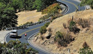 FILE - In this May 2014 photo, a bicyclist rides down Dead Indian Memorial Road near Ashland, Ore. Commissioners in Oregon&#39;s Jackson County decided not to change the name of Dead Indian Memorial Road even though the name remains controversial. (Jamie Lusch /The Medford Mail Tribune via AP, File)