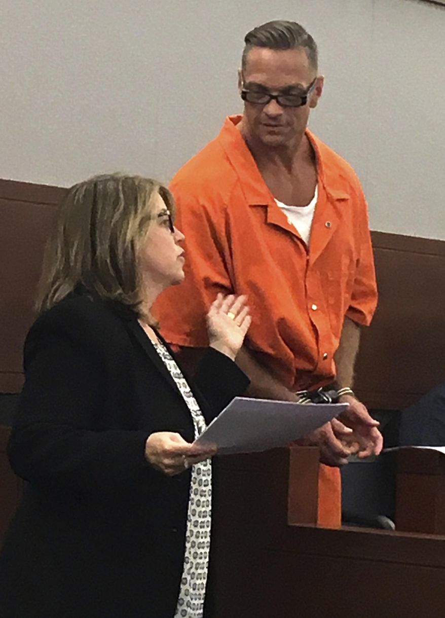FILE - In this Aug. 17, 2017, file photo, Nevada death row inmate Scott Raymond Dozier confers with Lori Teicher, a federal public defender involved in his case, during an appearance in Clark County District Court in Las Vegas. Questions arose about the upcoming execution of death row inmate Dozier, who wants to die, with a disclosure in court that the state official who signed off on the untried three-drug protocol has resigned. Clark County District Court Judge Jennifer Togliatti responded with surprise Tuesday, Oct. 31, 2017, when she was told that Dr. John DiMuro quit Monday, Oct. 30, as chief state medical officer. (AP Photo/Ken Ritter, File)