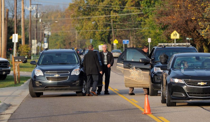 Michigan State Police investigate an officer involved shooting in Mattawan, Mich., Friday, Nov. 3, 2017. Authorities say the shooting during a traffic stop in southwestern Michigan left one person wounded and prompted the lockdown of nearby schools as a precaution. (Mark Bugnaski /Kalamazoo Gazette-MLive Media Group via AP)