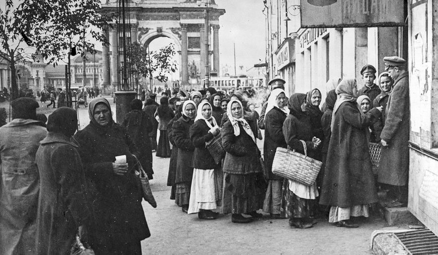 In this photo taken in Oct. 1917, provided by Russian State Documentary Film and Photo Archive, people line up to get food at Tverskaya Zastava, in Moscow, Russia. The 1917 Bolshevik Revolution was long before the digital revolution allowed anyone to instantly document events. But the clumsy cameras of the time still caught some images that capture the period's drama. (Russian State Documentary Film and Photo Archive via AP)