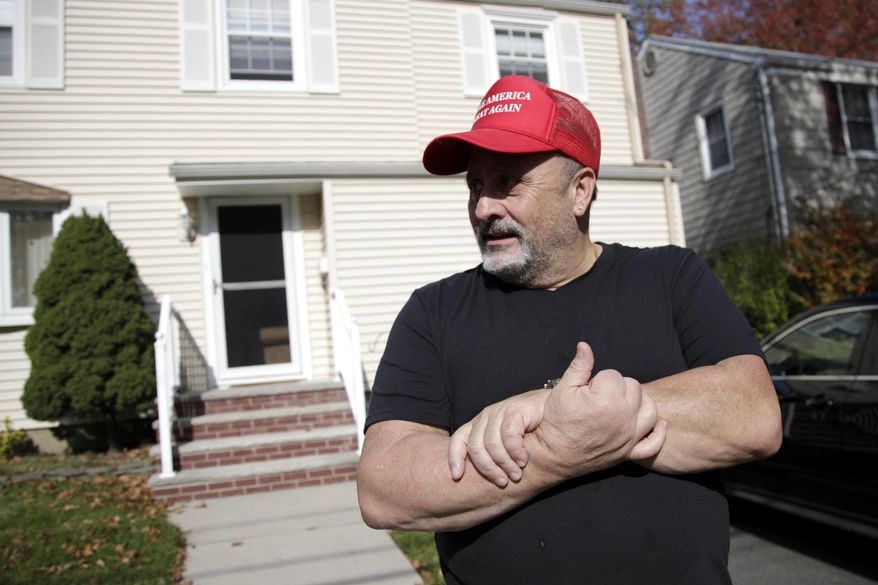 Frank Roselli stands on his front yard while letting his dog go for a walk, Friday, Nov. 3, 2017, in Bloomfield, N.J. Roselli, a widower who retired two years ago, is thinking of selling his home and moving to southern New Jersey, where he could potentially afford property taxes. (AP Photo/Julio Cortez)