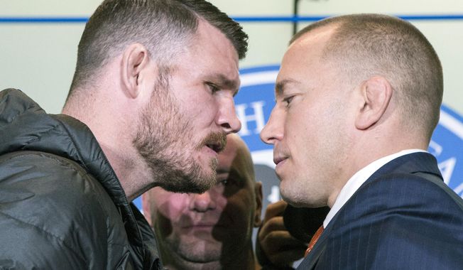 FILE - In this Oct. 13, 2017, file photo, Britain&#x27;s Michael Bisping, left, and Canada&#x27;s Georges St. Pierre face off during a news conference in Toronto, to promote their upcoming UFC 217. At center rear is UFC President Dana White. The pair square off on Saturday at Madison Square Garden in New York. (Chris Young/The Canadian Press via AP, File)