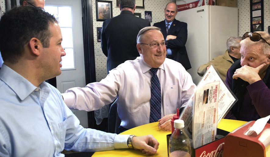 In a Jan. 27, 2016 photo, Maine Gov. Paul LePage, center, makes a full-on sales pitch for consolidating Lewiston and Auburn into one city during a lunchtime meeting with the mayors of both cities, Auburn Mayor Jonathan LaBonte, left and Lewiston Mayor Robert Macdonald, at Simones' Hot Dog Stand in Lewiston, Maine. Residents will have the final say Tuesday, Nov. 7, 2017 on whether to combine the two former mill cities that are separated by the Androscoggin River. (Russ Dillingham/The Lewiston Sun-Journal via AP)