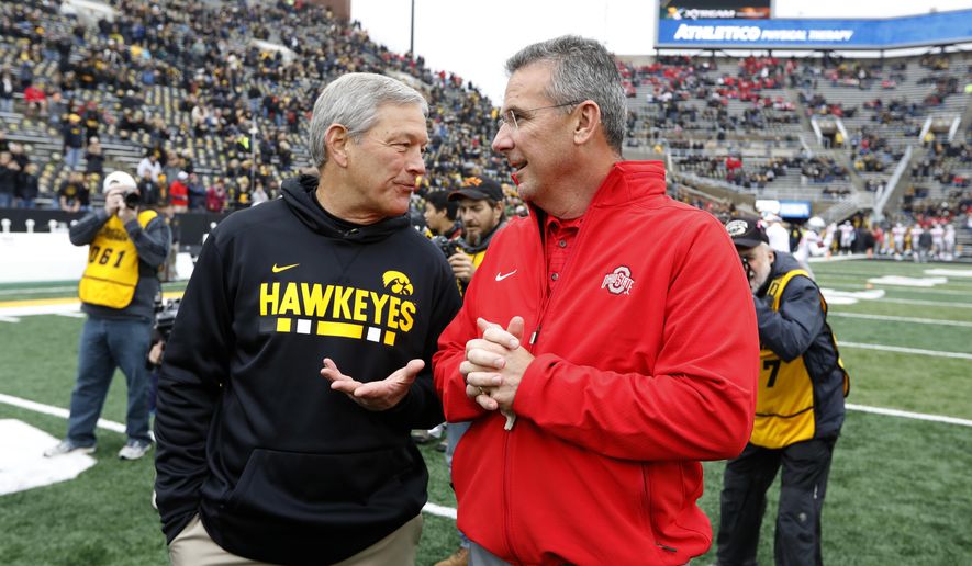 Iowa head coach Kirk Ferentz, left, talks with Ohio State head coach Urban Meyer before an NCAA college football game, Saturday, Nov. 4, 2017, in Iowa City, Iowa. (AP Photo/Charlie Neibergall)