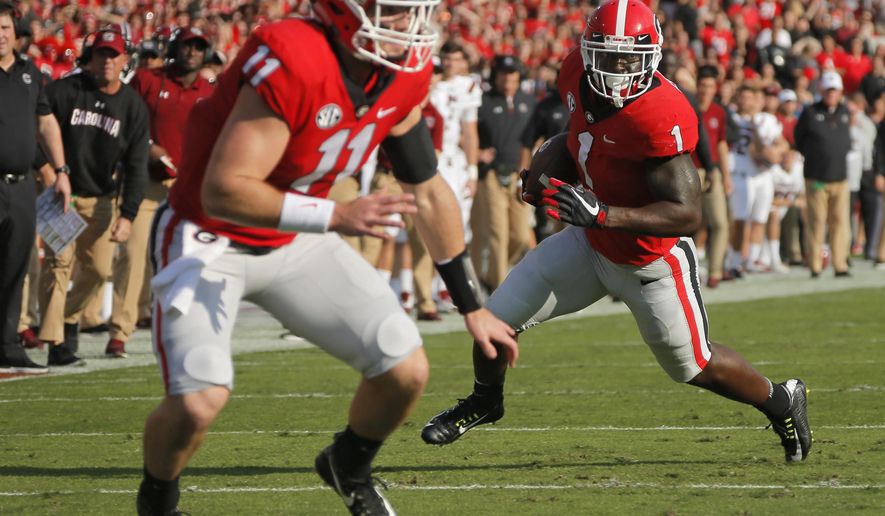 Georgia running back Sony Michel (1) runs for a touchdown against South Carolina with blocking from quarterback Jake Fromm (11) during an NCAA college football game Saturday, Nov. 4, 2017, in Athens, Ga. (Bob Andres/Atlanta Journal Constitution via AP)