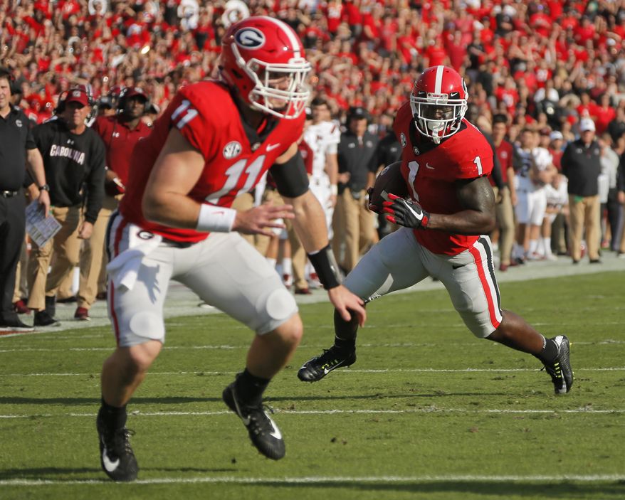 Georgia running back Sony Michel (1) runs for a touchdown against South Carolina with blocking from quarterback Jake Fromm (11) during an NCAA college football game Saturday, Nov. 4, 2017, in Athens, Ga. (Bob Andres/Atlanta Journal Constitution via AP)