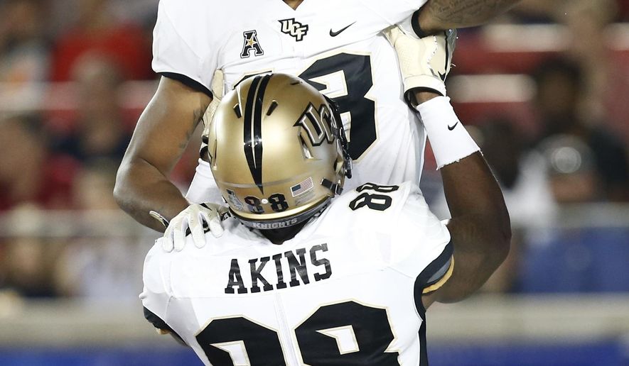 Central Florida wide receiver Gabriel Davis celebrates his touchdown catch against SMU with tight end Jordan Akins (88) during the first half of an NCAA college football game, Saturday, Nov. 4, 2017, in Dallas. (AP Photo/Mike Stone)