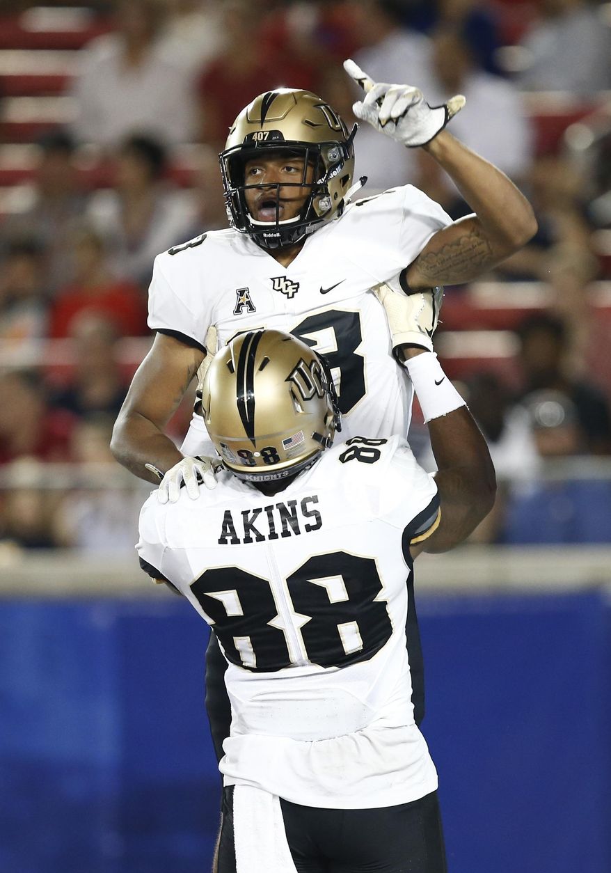 Central Florida wide receiver Gabriel Davis celebrates his touchdown catch against SMU with tight end Jordan Akins (88) during the first half of an NCAA college football game, Saturday, Nov. 4, 2017, in Dallas. (AP Photo/Mike Stone)