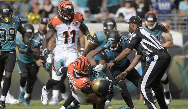 Cincinnati Bengals wide receiver A.J. Green (18) takes down Jacksonville Jaguars cornerback Jalen Ramsey (20) during a fight in the first half of an NFL football game Sunday, Nov. 5, 2017, in Jacksonville, Fla. (AP Photo/Phelan M. Ebenhack)