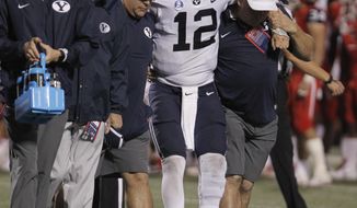BYU&#39;s quarterback Tanner Mangum is helped off the field with an injury against Fresno State during the second half of an NCAA college football game in Fresno, Calif., Saturday, Nov. 4, 2017. Fresno State won the game 20-13. (AP Photo/Gary Kazanjian)