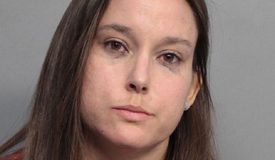 Bridget Freitas is seen in an undated photo provided by the Miami-Dade Police Department. Police have charged Freitas, a 30-year-old nurse, with felony battery on a police officer for her part in a videotaped altercation with a detective at a University of Miami football game. Police said Bridget Freitas slapped an officer while being carried out during Miami's win Saturday, Nov. 4, 2017, over Virginia Tech at Hard Rock Stadium. (Miami-Dade Police Department via AP)