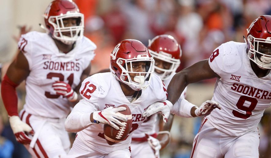 Oklahoma defensive back Will Johnson (12) celebrates with teammates after intercepting a pass in the end zone during an NCAA college football game against Oklahoma State, Saturday, Nov. 4, 2017, in Stillwater, Okla. (Ian Maule/Tulsa World via AP)