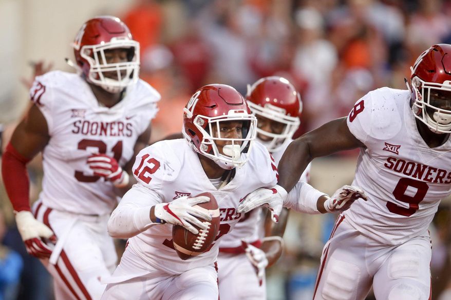 Oklahoma defensive back Will Johnson (12) celebrates with teammates after intercepting a pass in the end zone during an NCAA college football game against Oklahoma State, Saturday, Nov. 4, 2017, in Stillwater, Okla. (Ian Maule/Tulsa World via AP)