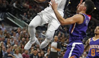 After a steal San Antonio Spurs&#39; Brandon Paul(3) drives for two as Phoenix Suns Devin Booker watches in a NBA game on Sunday, Nov. 5, 2017 in San Antonio. (AP Photo/Ronald Cortes)