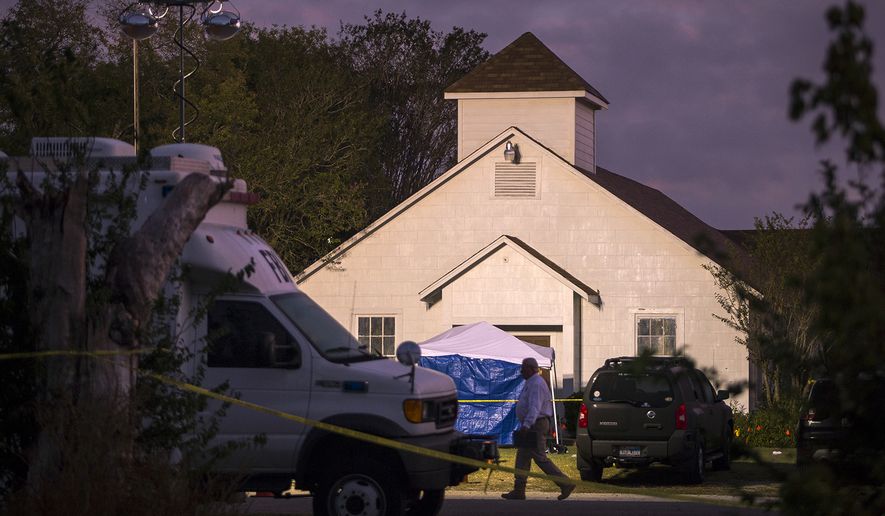 A man walks past the front of the First Baptist Church on Monday, Nov. 6, 2017, where a gunman opened fire on a Sunday service in Sutherland Springs, Texas. (Nick Wagner/Austin American-Statesman via AP)