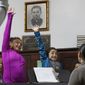 In this Oct. 26, 2017, photo, Dulce Carvajal, 10, second from left, and her sister Daniela, 8, raise their hands during voice lessons at the Holyrood Episcopal Church in the Bronx borough of New York. Since August, the girls and their brother have been living inside the church with their mother, a Guatemalan immigrant living illegally in the United States. At least two dozen immigrants have sought sanctuary at U.S. churches since the Immigration and Customs Enforcement agency stepped up arrests by 40 percent under President Donald Trump. (AP Photo/Kathy Willens)