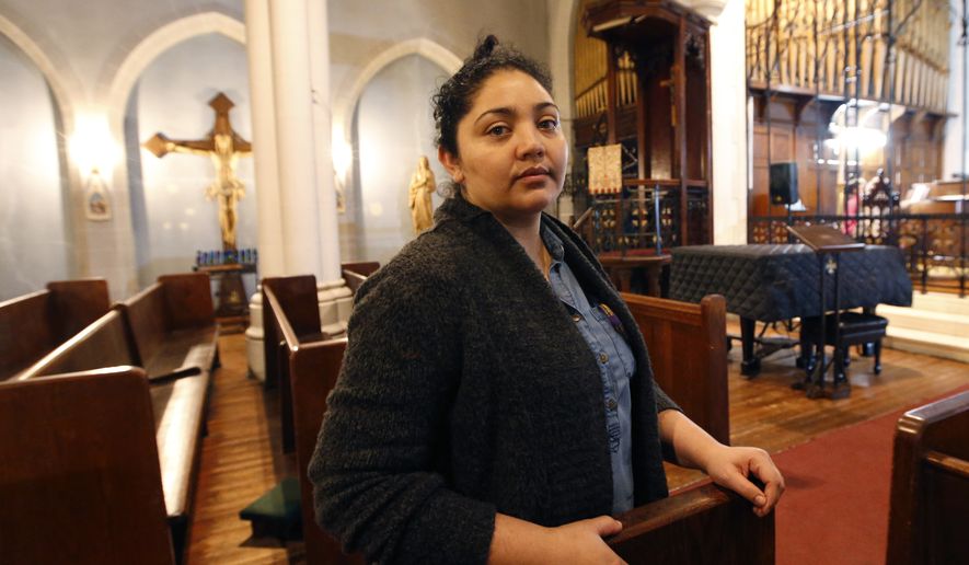 In this Oct. 26, 2017, photo, Amanda Morales poses for a photograph in the sanctuary of the Holyrood Episcopal Church, the Bronx borough of New York. Morales has been living in the gothic church at the northern edge of Manhattan since August, shortly after immigration authorities ordered her deported to her homeland of Guatemala. (AP Photo/Kathy Willens) ** FILE **